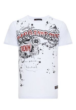 Weißes Baumwoll-T-Shirt mit schwarzen und roten Grafikdrucks, Spritzdetails, Rundhalsausschnitt und kurzen Ärmeln. Markenlabel am Saum.