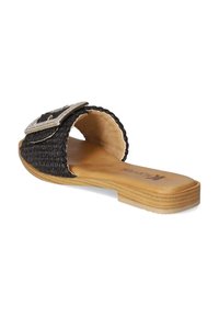 Black woven slide sandal with a wide strap and a rhinestone-accented buckle. Features a tan footbed and low, flat sole.