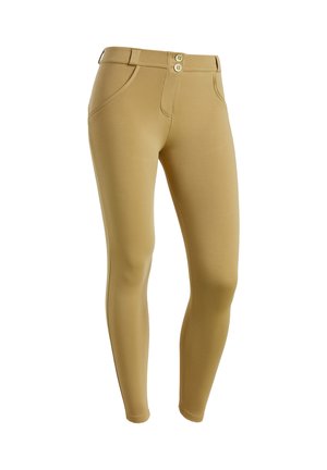 Leggings beiges en tissu extensible, dotés d'une taille haute, d'une fermeture à deux boutons, de poches latérales et d'une silhouette ajustée.