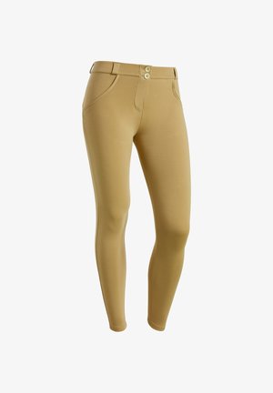 Leggings beiges en tissu extensible, dotés d'une taille haute, d'une fermeture à deux boutons, de poches latérales et d'une silhouette ajustée.