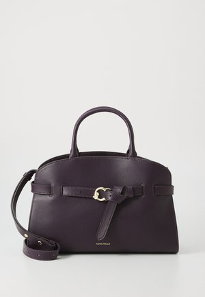 Purple leather handbag with a structured design, dual handles, and removable strap. Features a front belt accent and gold hardware detail.