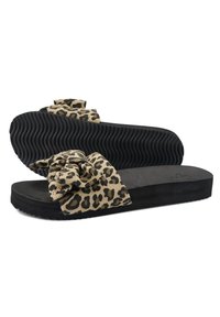 Leopard print slide sandals with a fabric bow, black rubber sole, textured underfoot, and soft padded footbed for comfort.