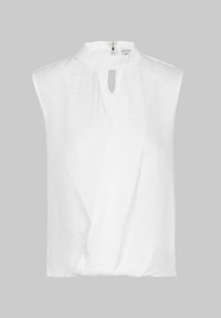 White sleeveless blouse with a high collar, featuring a front keyhole opening and textured fabric. Design includes asymmetric draping.
