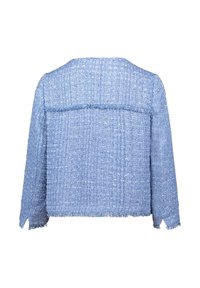 Blue textured jacket with a loose fit, frayed edges, and a boxy shape. The fabric appears woven and has a subtle check pattern.