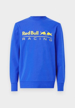 Modrá mikina vyrobená z bavlny, s rebrovaným okrúhlym výstrihom a dlhými rukávmi. Na prednej strane sa nachádza veľké žlté logo "Red Bull Racing".