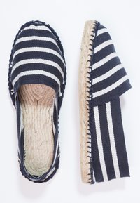Marineblaue und weiße gestreifte Espadrilles mit einem Textil-Obermaterial, Jutesohle und geflochtenen Kanten. Offenes Rückendesign für einfaches Anziehen.