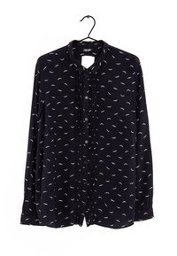 Blusa a maniche lunghe di un blu navy scuro con un piccolo motivo a piume bianche, fronte con bottoni e colletto classico. Tessuto morbido con una vestibilità leggermente ampia.