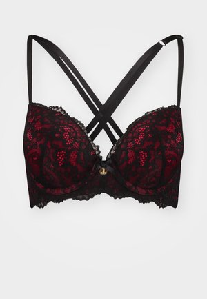 Lace push-up bra in black and red, featuring crisscross straps, a scalloped lace edge, and a central bow with metallic detailing.