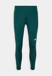 Legginsy w ciemnym odcieniu tealu, elastyczny materiał z wysokim stanem. Posiadają małe białe logo na dolnej części nogawki. Gładka tekstura, dopasowany krój.