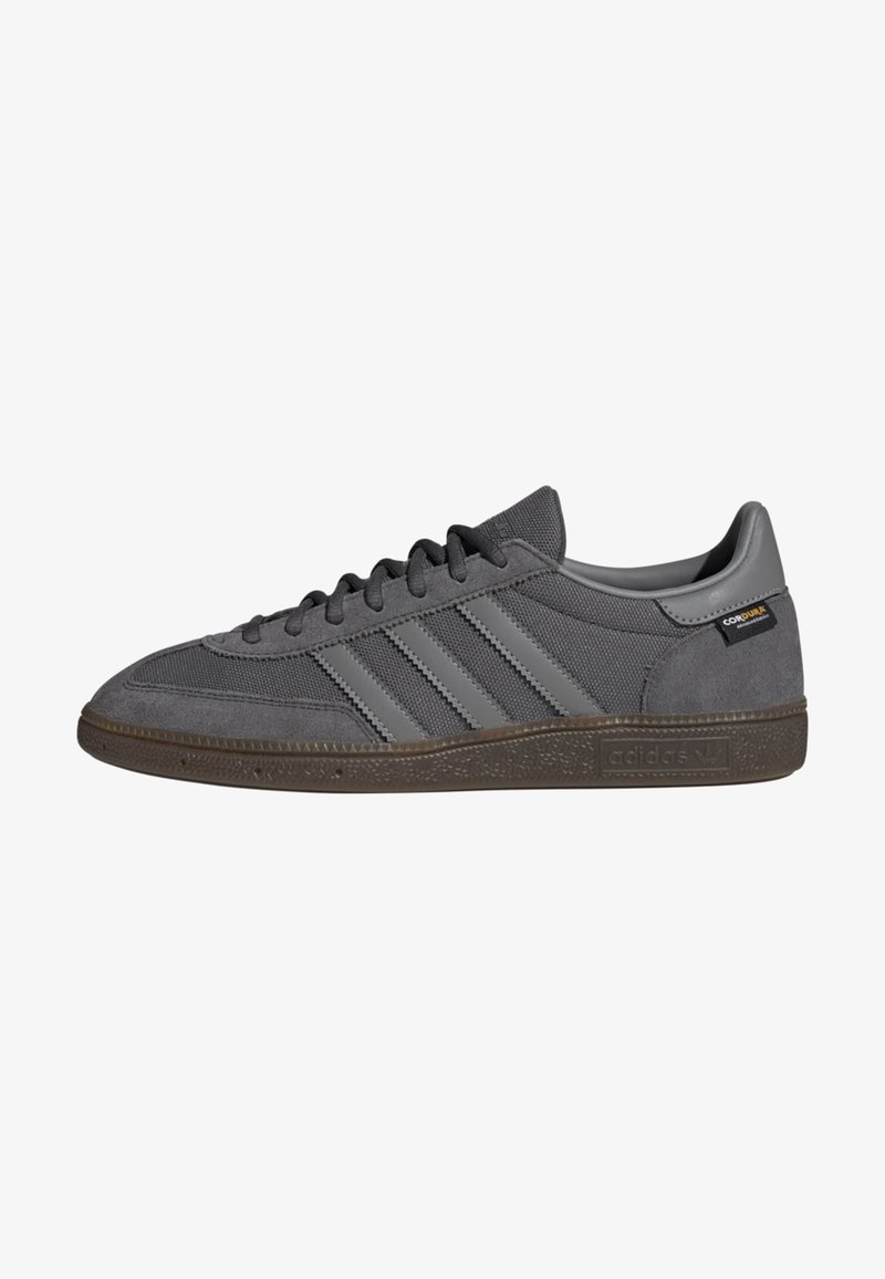 Gray sneakers with a textile and suede upper, featuring three diagonal stripes, padded collar, and rubber outsole.