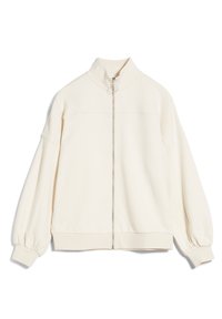 Giacca zip-up di colore crema chiaro con colletto alto, vestibilità oversize, polsini a coste e una texture liscia. Presenta una zip centrale e cuciture a pannello.