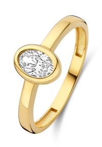 Gold ring featuring an oval cut clear gemstone, smooth finish, and a minimalist design. The band is polished and slender.