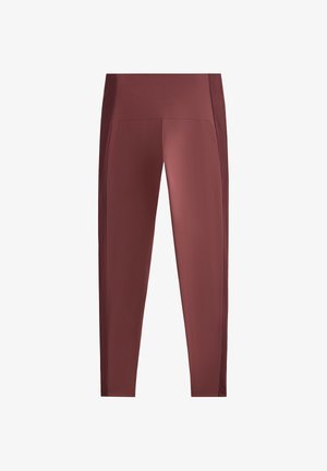 Legice z visokim pasom, tesno prilegajoče se, v globoki bordo barvi, z reliefnimi stranskimi paneli za več podrobnosti in prožnost.