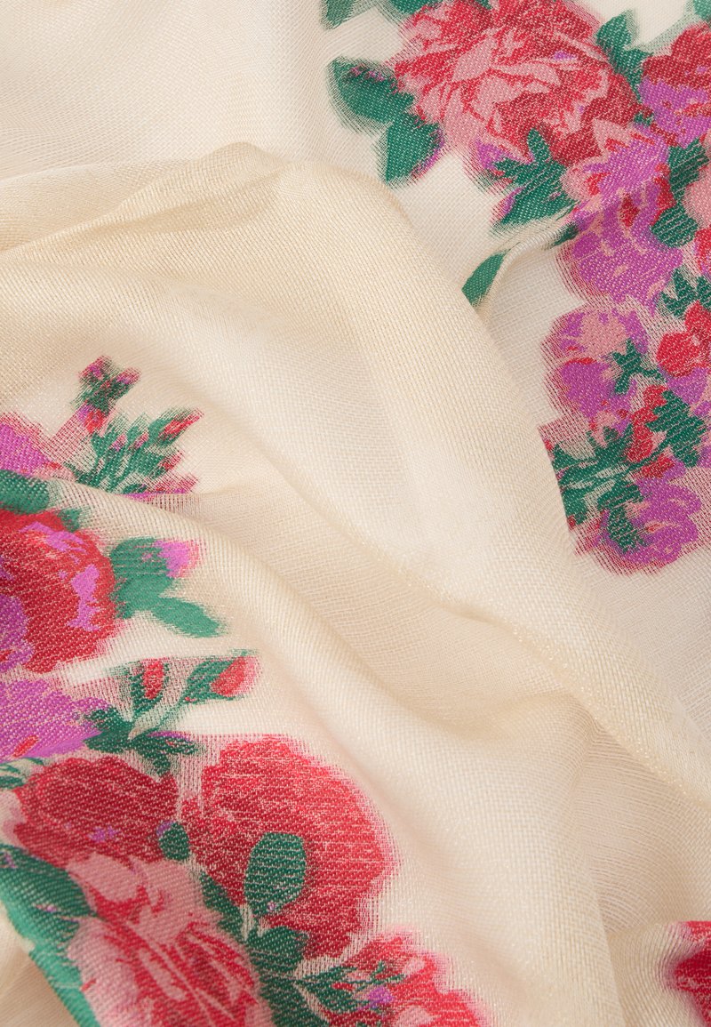 Lightweight, sheer fabric scarf in cream with floral pattern featuring red and purple flowers and green leaves. Smooth texture, soft drape.