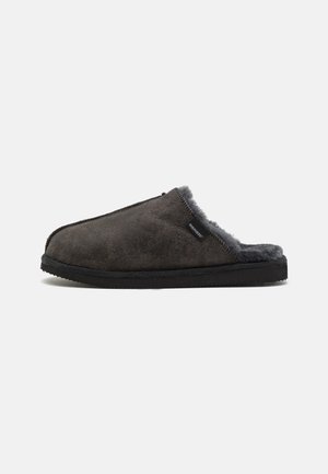 Dark gray suede slip-on slipper with black sole and soft gray fleece lining, viewed from the side against a white background.