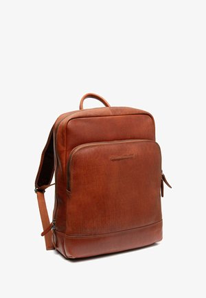 Brown leather backpack featuring a front zipper pocket, padded shoulder straps, and a top handle. Smooth texture with subtle branding detail.