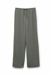 Pantalons en tissu léger et côtelé couleur vert foncé. Dotés d'une taille élastique avec cordon de serrage et de jambes évasées avec des bords festonnés.