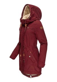 Giacca parka color marrone scuro con cappuccio in pile trapuntato, vita regolabile con cordino, bottoni a pressione e cuciture decorative. Lunghezza media con tasche laterali.