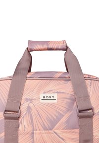 Ruksak Roxy s tropickým vzorom v ružovej a levanduľovej farbe, vybavený polstrovanou rukoväťou a nastaviteľným, textúrovaným popruhom.