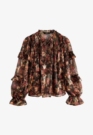 Kergelt läbipaistev must blouse lillemustriga punases, kuldses ja rohelises. Omab voltidega varrukaid ja sõlmpaela kaeluses. Tekstureeritud kangas pehme läikega.