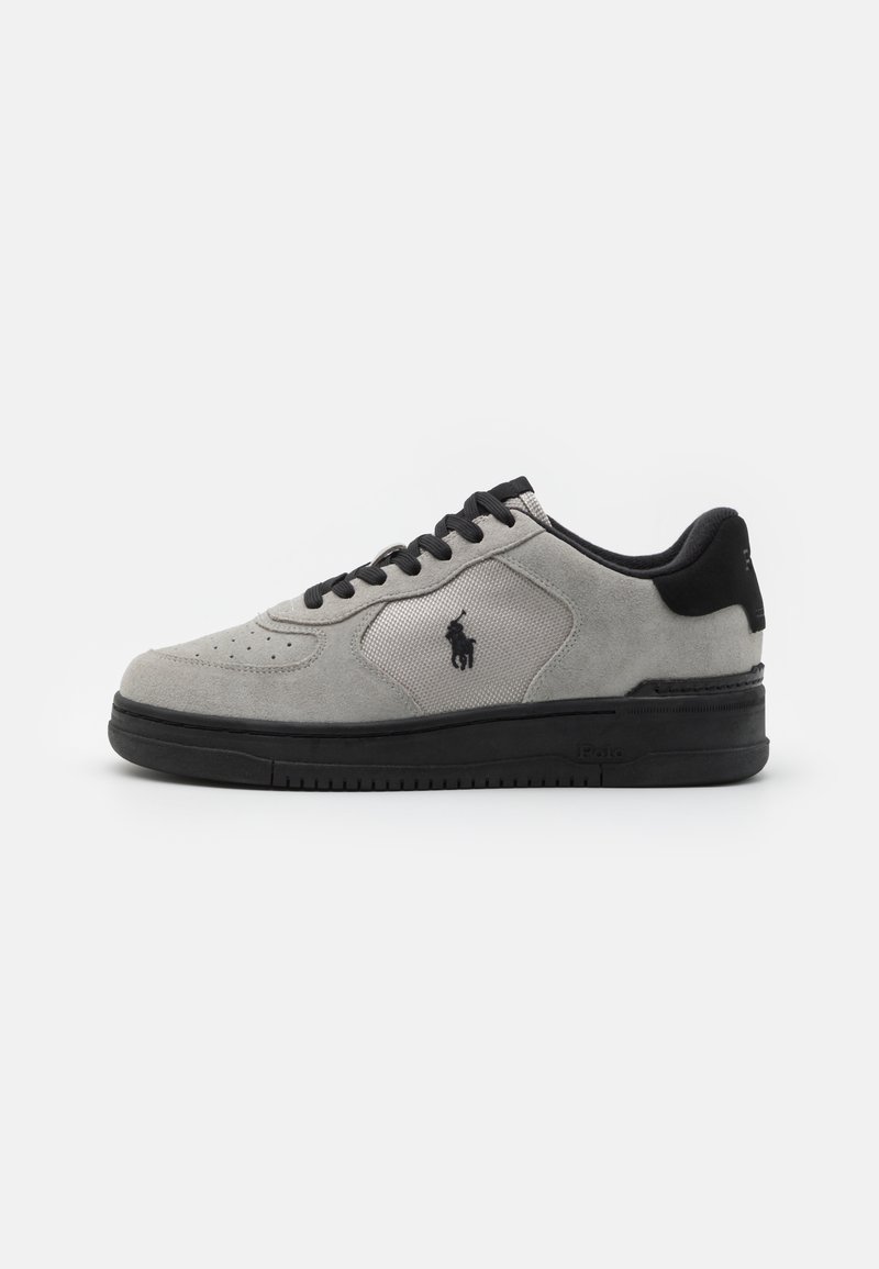 Gray suede sneakers with black accents, featuring a textured fabric side panel, round toe, and black rubber sole. Logo embroidered on the side.