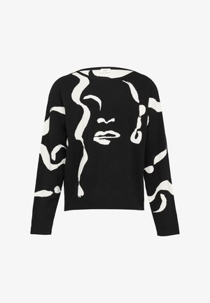 Zwarte trui met een witte abstracte afbeelding die op een gezicht lijkt, met lange mouwen en een relaxte pasvorm. Gemaakt van zachte stof met een gladde textuur.