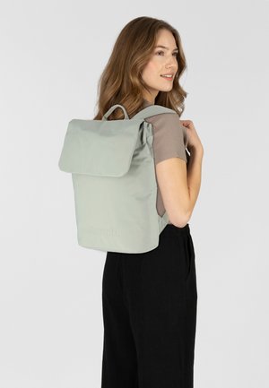 Light green backpack made of smooth material, with a folded flap and two shoulder straps. Features a subtle logo on the front.