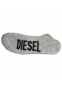 Calcetín gris con la marca "DIESEL" en negro en el lateral. El material parece suave, con una textura lisa y un diseño de punta redondeada.