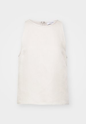 Bezgala topiņa gaiši bēšā krāsā, izgatavota no mīksta auduma, ar apaļu dekoltē un slēptu aizmugures rāvējslēdzēju. Vienkārša un gluda tekstūra.