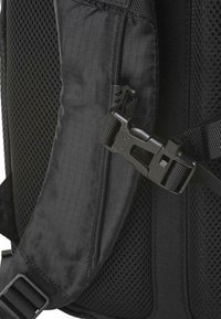 Correa de mochila negra con un tejido texturizado, panel de malla y una hebilla de plástico con una correa ajustable para un cierre seguro.