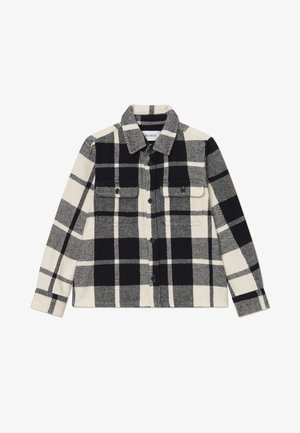 Black and white plaid flannel shirt with two chest pockets, button closure, and a collared neck. Soft texture and structured shape.