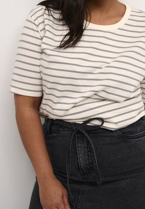 Striped short-sleeve shirt in cream and grey, featuring a crew neckline, paired with a high-waisted black denim skirt with a tied belt.