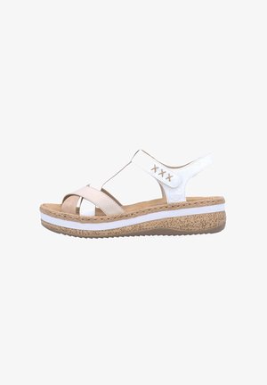 Sandale blanche et beige avec une semelle en liège, des sangles entrecroisées et un dos fermé. Présente une plateforme texturée et un accent cousu.