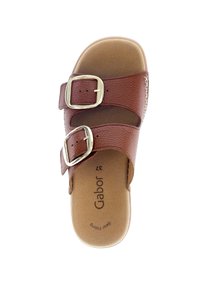 Brown leather slide sandal with two adjustable straps and gold-tone buckles. Soft insole with embossed brand logo and decorative stitching.