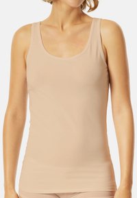 Débardeur beige en tissu lisse et extensible. Doté d'un décolleté en U et de bretelles larges. Design ajusté avec un ourlet droit.