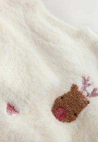 Fuzzy white fabric featuring a brown reindeer face with a red nose and pink sequined antlers, accented by two small red circular details.