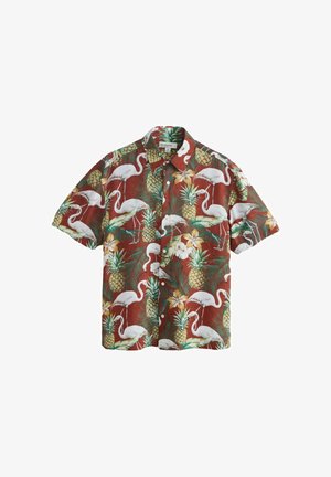 Short-sleeve button-up shirt with tropical print featuring white flamingos, pineapples, green leaves, and yellow flowers on a rust background.