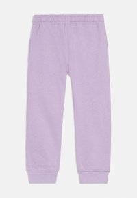Lilac sweatpants made of soft fabric, featuring an elastic waistband and tapered cuffs. No visible patterns or hardware details.