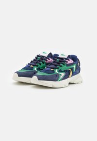 Navy blue athletic shoes with mesh and suede material; features green, pink, and yellow accents. Thick white sole with textured tread.