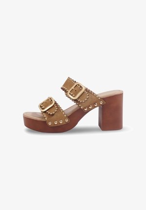 Sandale marron à talon plateforme à bout ouvert avec deux brides à boucles cloutées et un talon bloc en bois épais sur fond blanc.