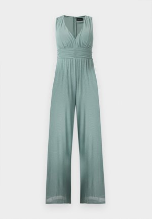 Αμάνικη ολόσωμη φόρμα σε χρώμα φασκόμηλου με βαθύ V-ντεκολτέ, σφηκοφωλιά στη μέση, φαρδιά παντελόνα και φερμουάρ στην πλάτη.