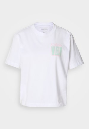 White cotton t-shirt with short sleeves and a crew neck. Features "Calvin" in pink and "KLEIN" in green printed on the front.