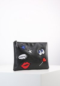 Czarna skórzana saszetka z kolorowymi haftowanymi motywami: czerwone usta, niebieskie gwiazdy, oczy, dymek z napisem "meow!" oraz serce.