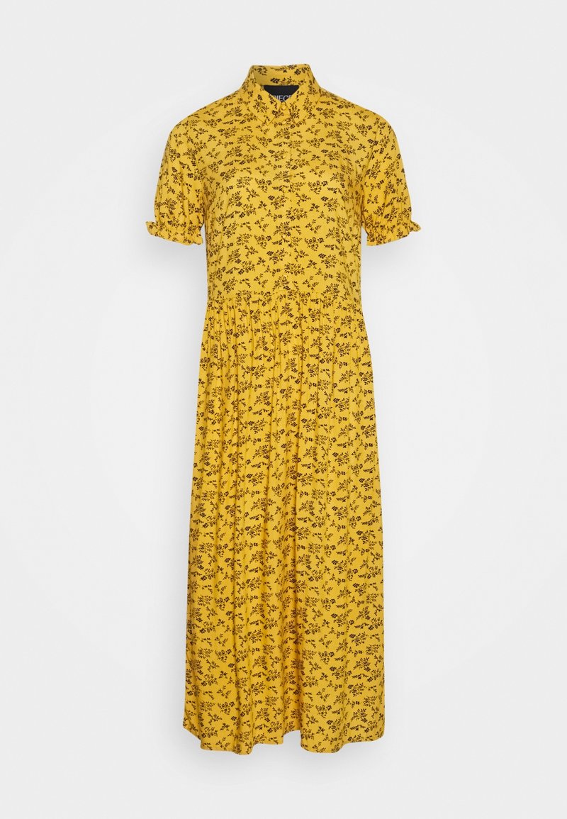 Robe fleurie jaune avec des manches courtes à volants, un col et une jupe fluide. Présente un motif floral noir sur l'ensemble.