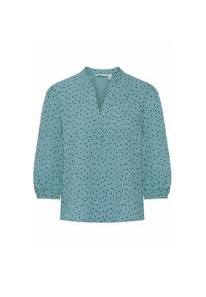 Šviesiai mėlynas palaidinė su V formos iškirpte, trijų ketvirčių pūsto pobūdžio rankovėmis ir subtiliu juodu raštu. Pagaminta iš minkštos, tekstūruotos medžiagos.