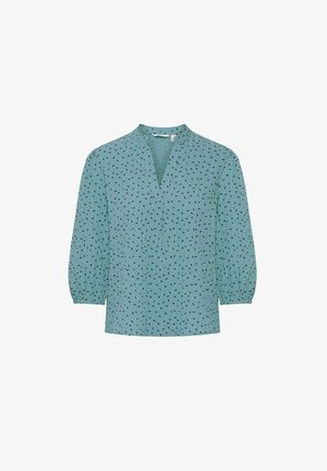 Svetle modrá blůza s výstřihem do V, 3/4 nadýchanými rukávy a jemným černým vzorem. Vyrobena z jemné strukturované látky.