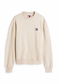 Beige Rundhals-Sweatshirt aus einem Baumwollmischgewebe. Mit Rippenbündchen und Saum, sowie einem kleinen Logopatch auf der Brust. Glatte Textur.