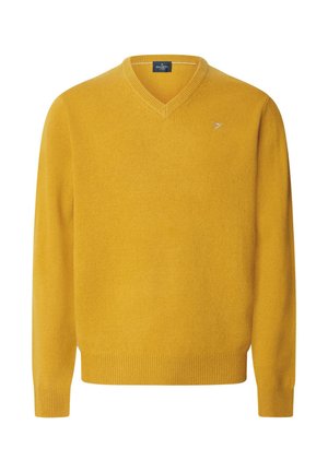 Jersey de color amarillo mostaza con cuello en V, mangas largas y puños y dobladillo de canalé, con un pequeño logo bordado en el pecho izquierdo.