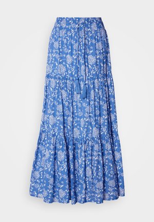 Falda maxi azul con flores y patrones blancos, con volantes fruncidos y una cinturilla con cordón que presenta borlas en el dobladillo. Material de algodón.