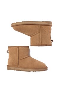 Tan suede ankle boots with a soft texture, rounded toe, and elastic panel. The rubber sole features a low profile for comfort.